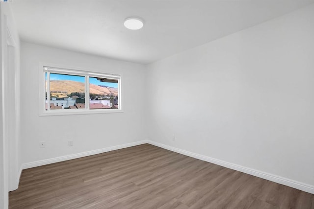 spare room with dark wood-type flooring