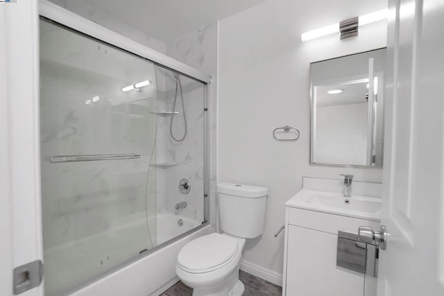 full bathroom featuring shower / bath combination with glass door, vanity, and toilet