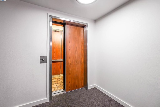 interior space with carpet floors and elevator