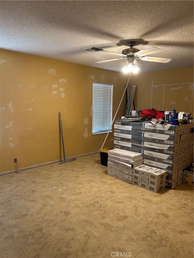 bedroom featuring a textured ceiling and ceiling fan