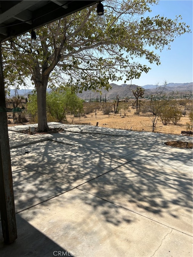 view of patio / terrace with a mountain view