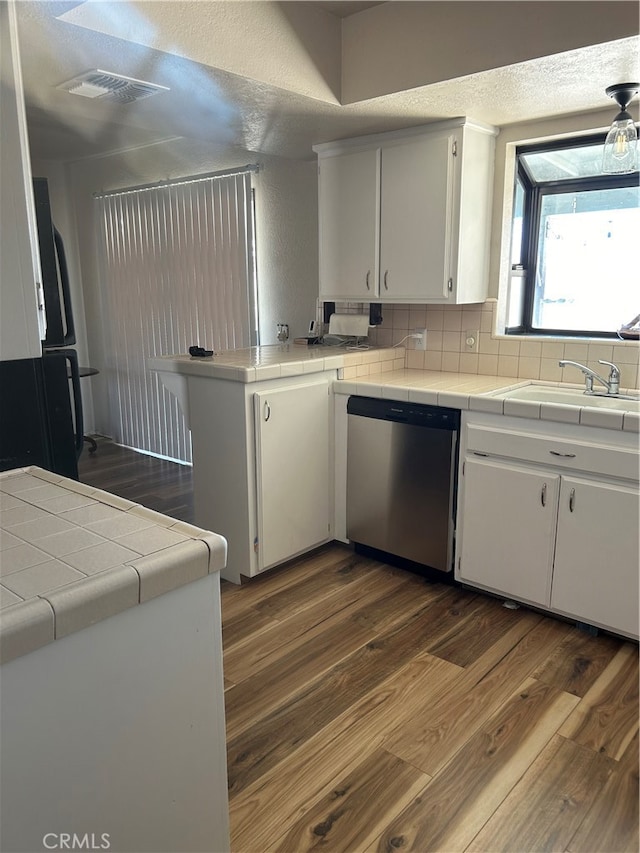 kitchen featuring tile countertops, dishwasher, dark hardwood / wood-style floors, and white cabinetry