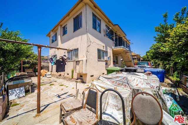 rear view of property featuring a patio area