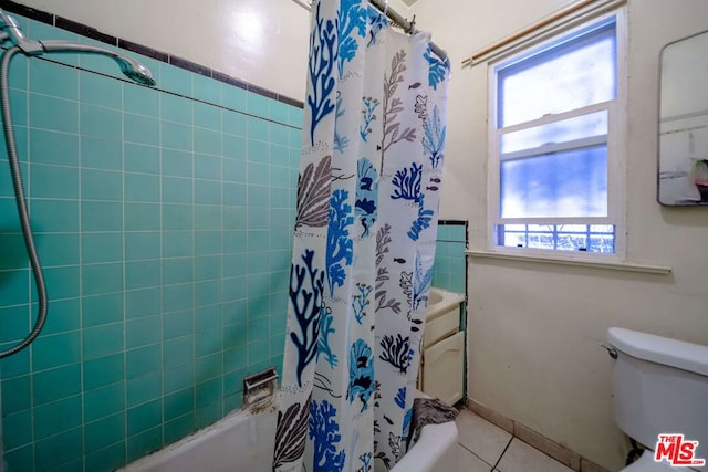 bathroom with shower / bath combo with shower curtain, toilet, and a wealth of natural light