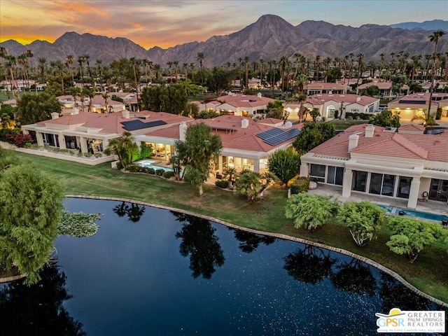 aerial view at dusk with a water and mountain view