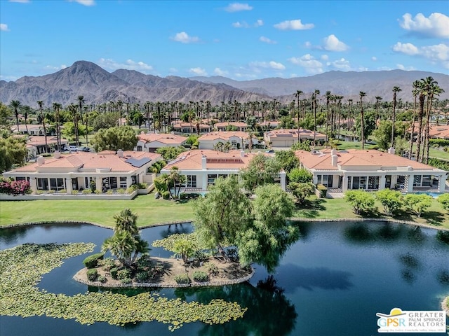 drone / aerial view with a water and mountain view