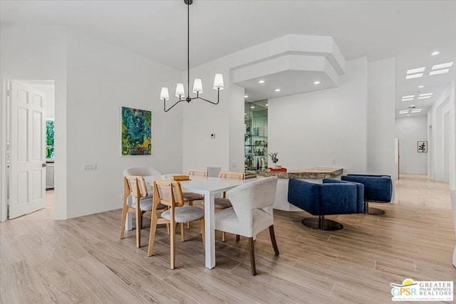 dining room with an inviting chandelier and light hardwood / wood-style flooring