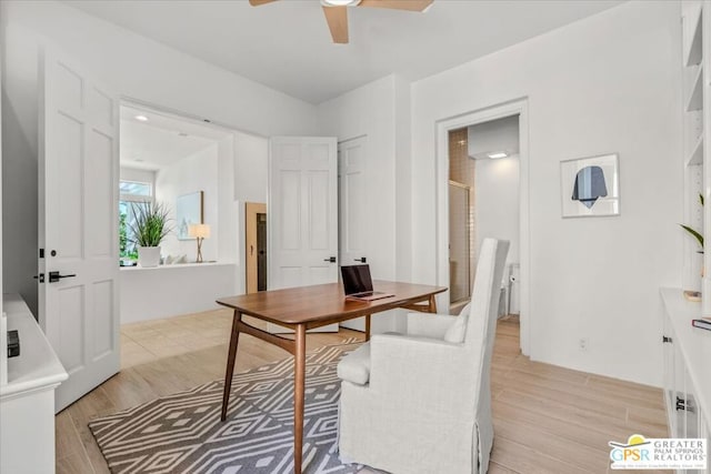 home office with ceiling fan and light hardwood / wood-style floors