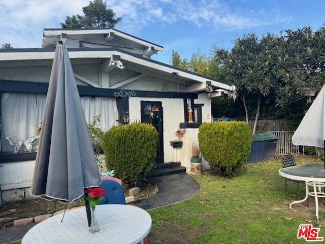 property entrance with a lawn