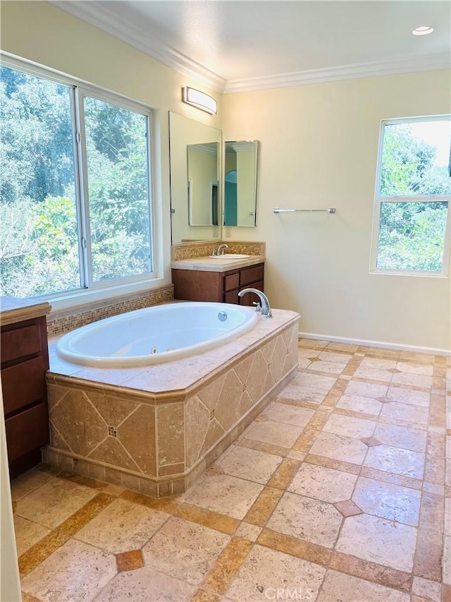 bathroom featuring vanity, plenty of natural light, a relaxing tiled tub, and ornamental molding