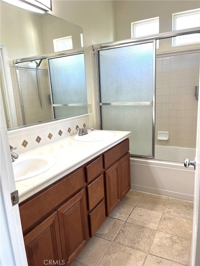 bathroom with shower / bath combination with glass door and vanity