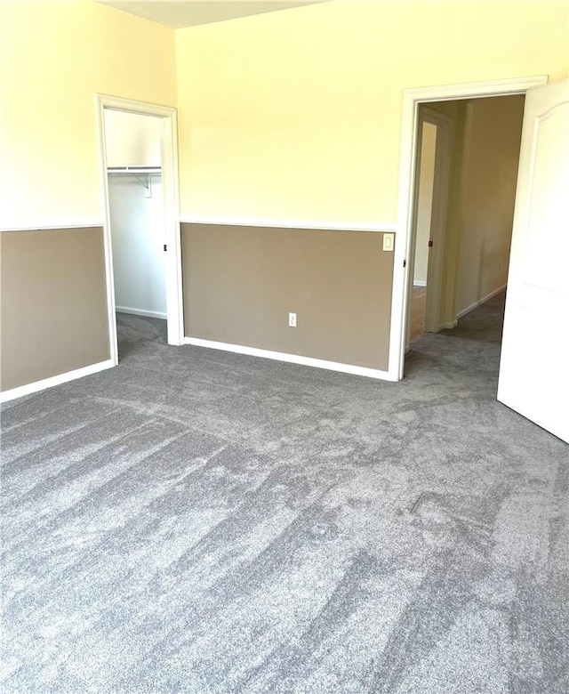 spare room with dark colored carpet