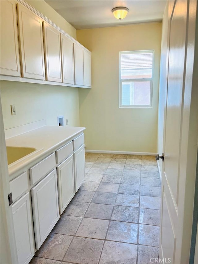 washroom with washer hookup, cabinets, and sink