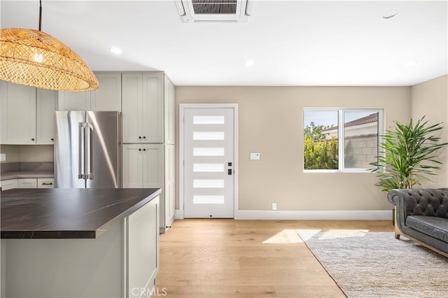 kitchen with decorative light fixtures, light hardwood / wood-style flooring, high end refrigerator, and gray cabinetry