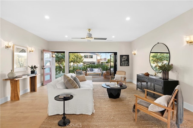 living room with ceiling fan and light hardwood / wood-style floors