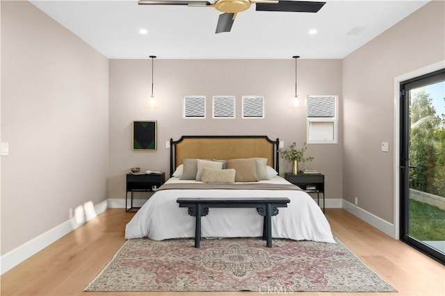 bedroom featuring light wood-type flooring, ceiling fan, and access to outside