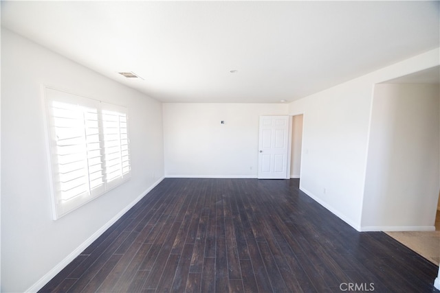 spare room featuring wood-type flooring