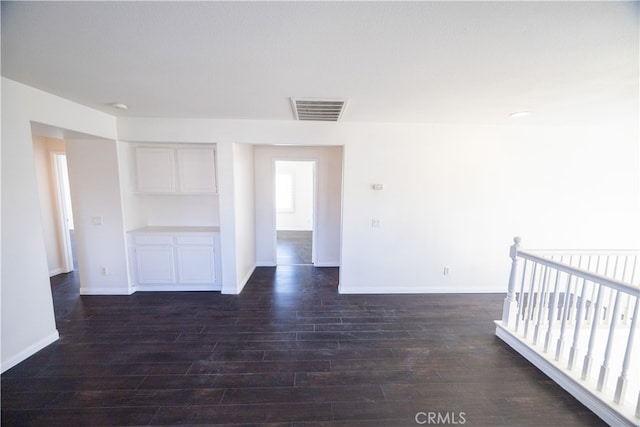 unfurnished room featuring dark hardwood / wood-style floors