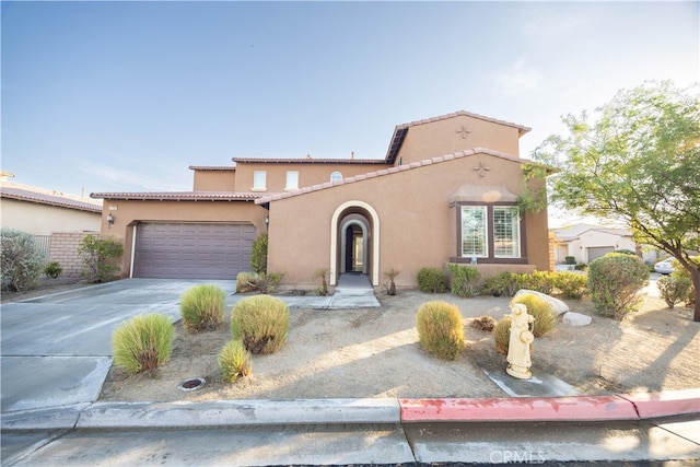 mediterranean / spanish home featuring a garage