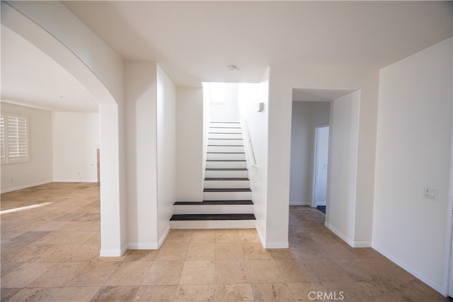 stairs featuring light tile patterned floors