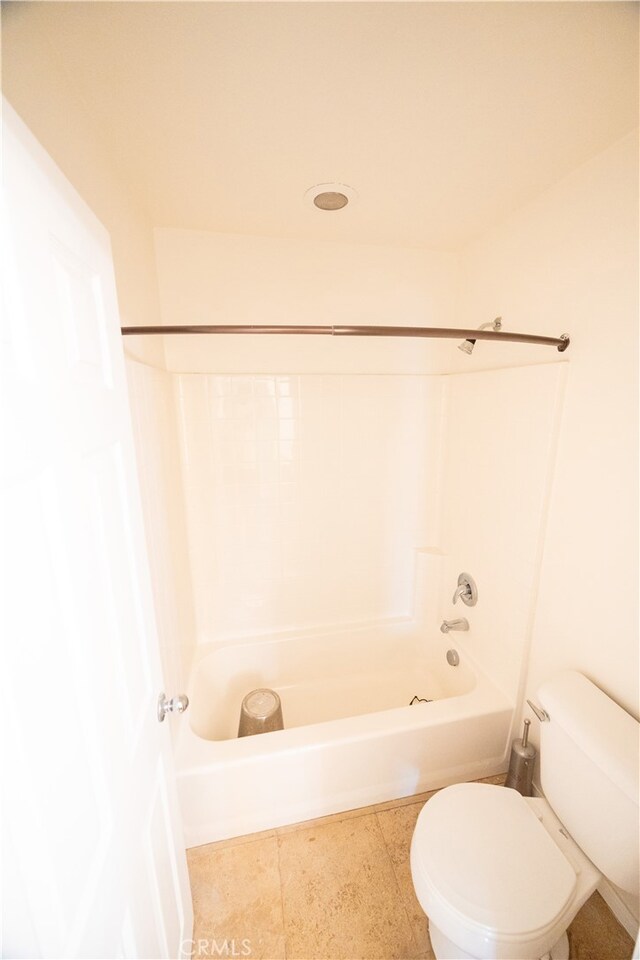 bathroom with tile patterned floors, toilet, and tub / shower combination