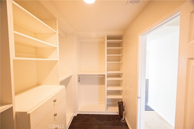 walk in closet featuring dark wood-type flooring