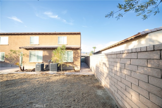 rear view of house featuring a patio and cooling unit