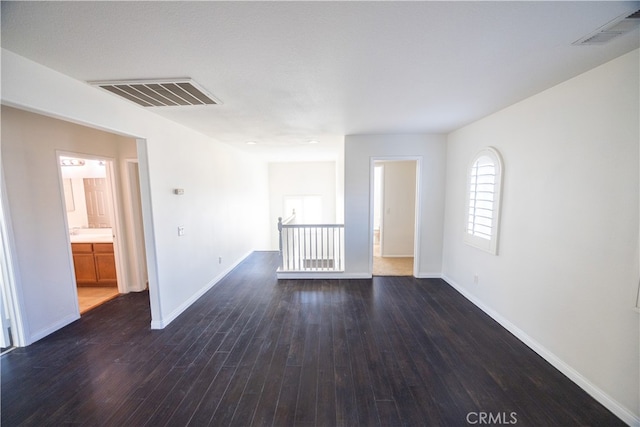 unfurnished room featuring dark wood-type flooring