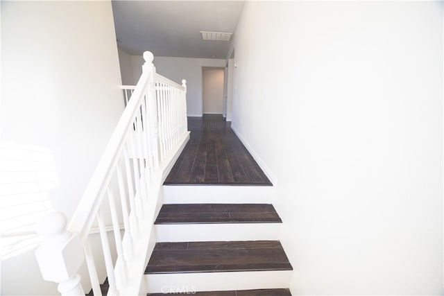 stairway featuring hardwood / wood-style floors