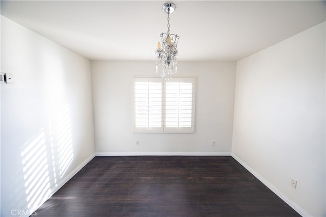 unfurnished room featuring wood-type flooring and a chandelier