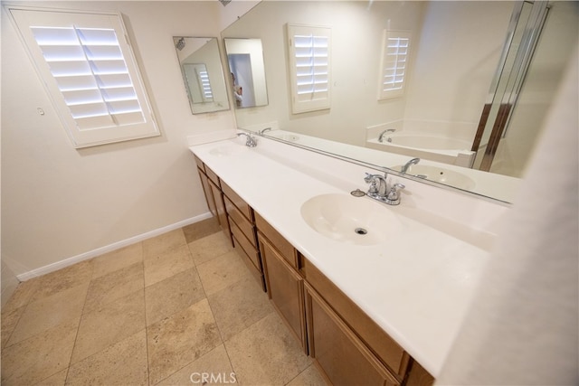 bathroom with double vanity, tile patterned flooring, and a washtub