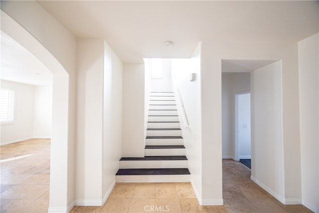 stairs featuring light tile patterned floors