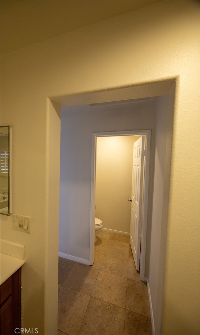 bathroom featuring tile patterned floors, toilet, and vanity