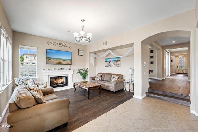 living room featuring light hardwood / wood-style floors and a notable chandelier