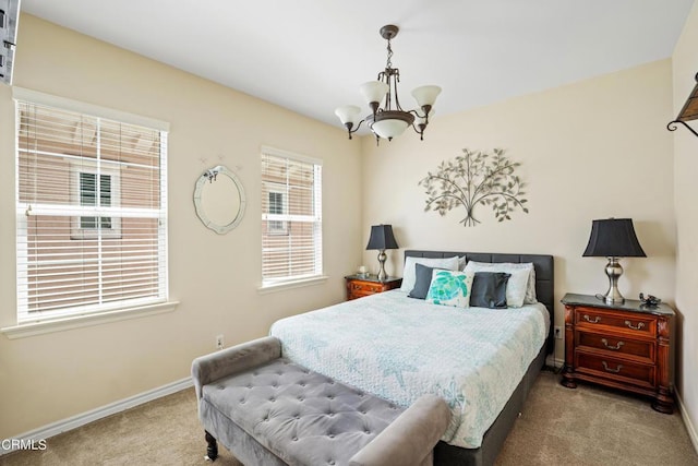 carpeted bedroom with a chandelier