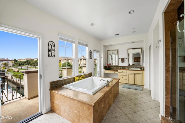 bathroom featuring tile patterned floors, vanity, and plus walk in shower