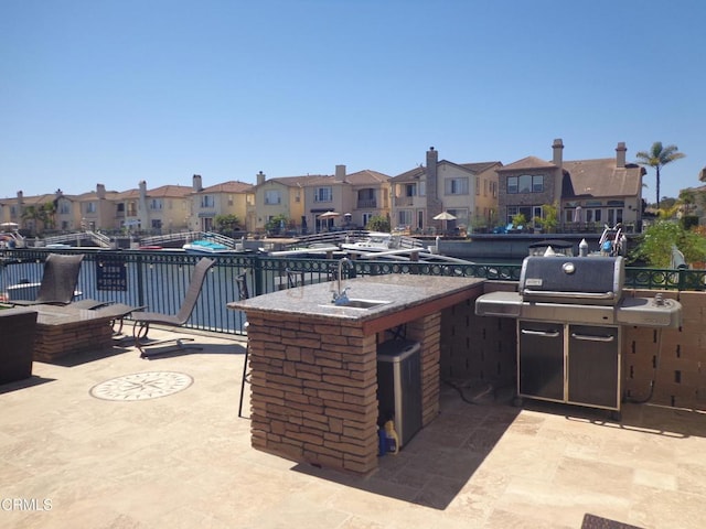 view of patio / terrace featuring grilling area and a wet bar