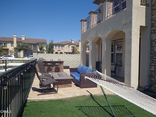 view of patio featuring an outdoor hangout area and a balcony