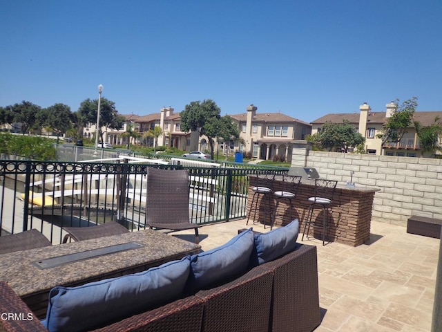 view of patio with an outdoor hangout area and a bar