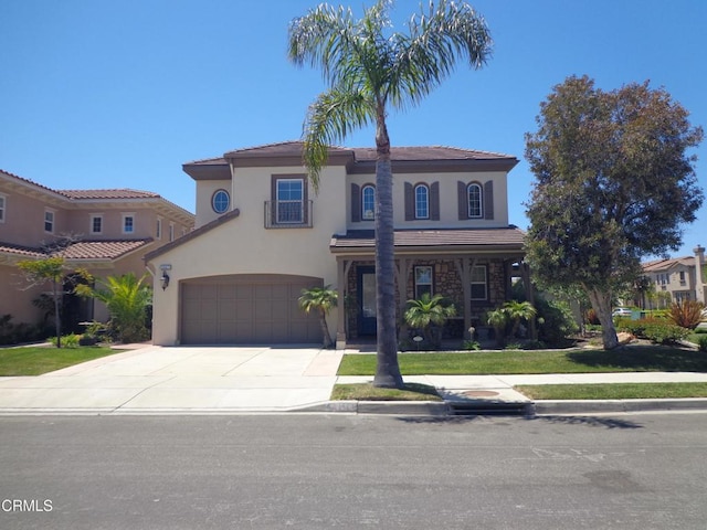 mediterranean / spanish-style house with a front yard and a garage