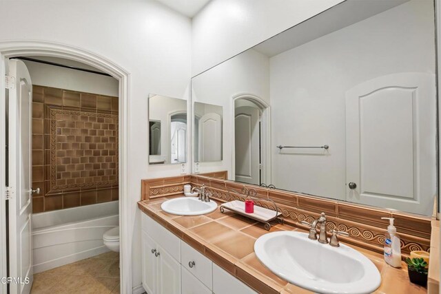 bathroom featuring tile patterned floors, vanity, and toilet