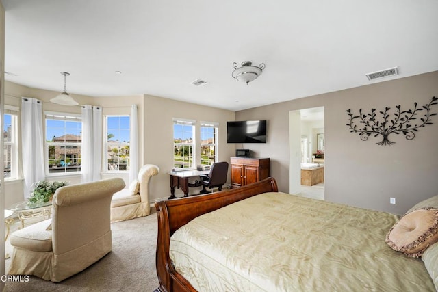 bedroom featuring light carpet and connected bathroom