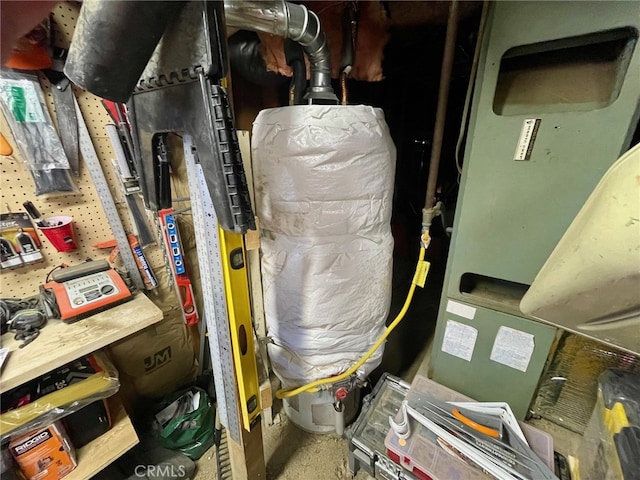 utility room featuring water heater