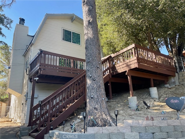 back of property featuring a wooden deck