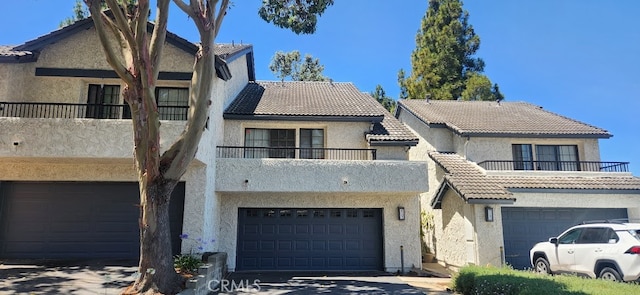 view of property with a garage and a balcony