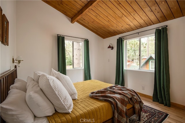 bedroom featuring light wood-type flooring, vaulted ceiling with beams, and wooden ceiling