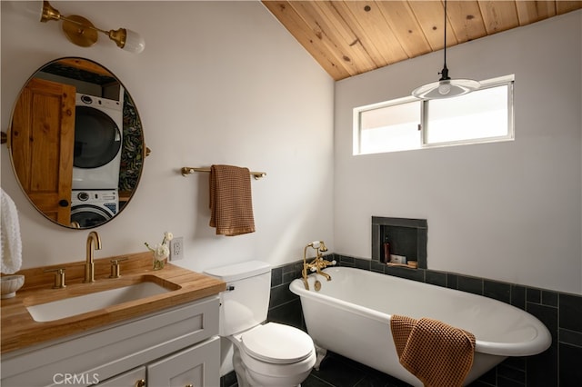 bathroom featuring a bathtub, stacked washing maching and dryer, vanity, wooden ceiling, and toilet