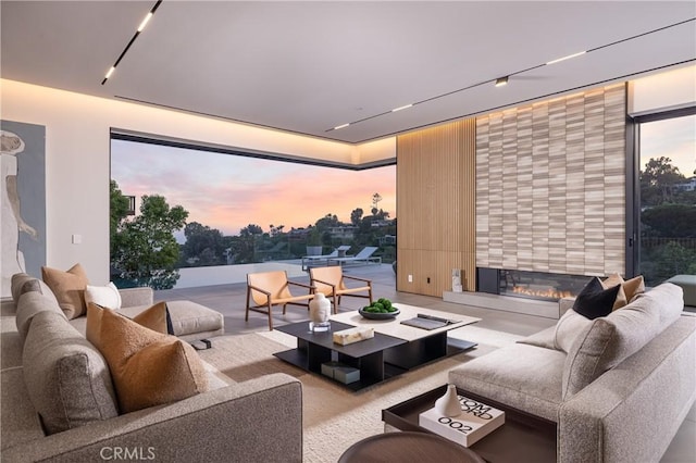 home theater room featuring rail lighting and a large fireplace