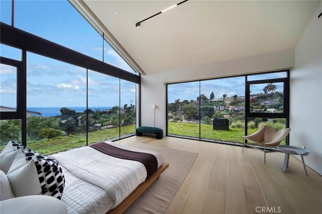 sunroom featuring a water view