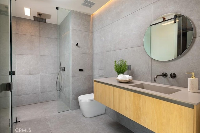 bathroom featuring toilet, a shower, tile walls, and vanity